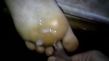 He pours sperm on her feet