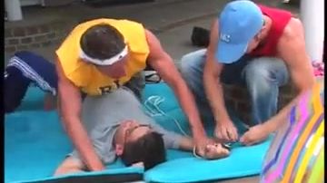 Two guys have fun with a tied-up guy