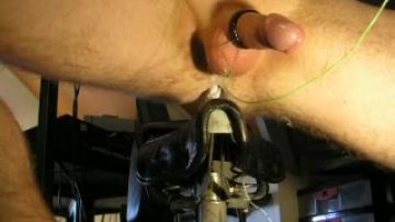 Man stimulates his cock in fetish situation