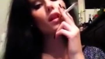 A sultry brunette slowly smokes for you